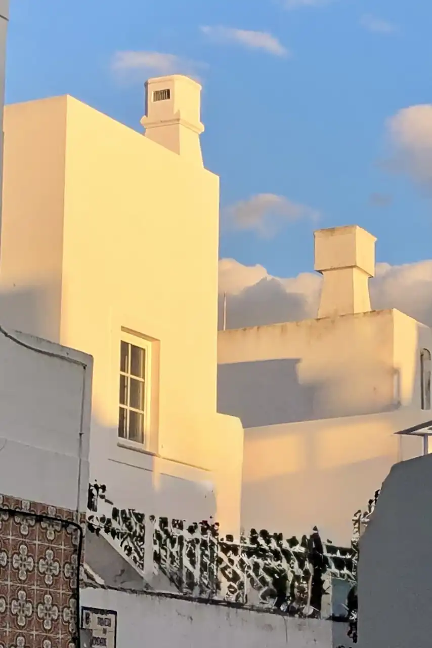 Cubist architecture in Olhão in the sunset against a blue sky